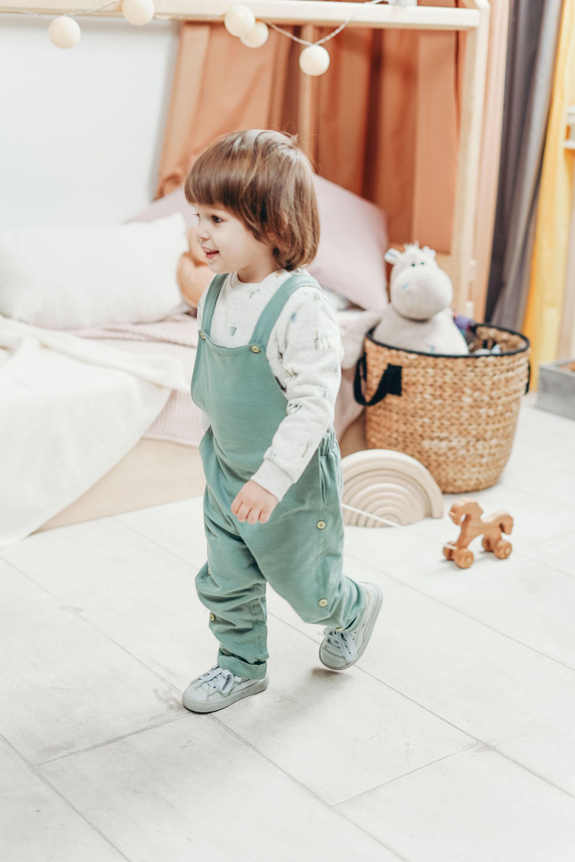 Adorable child playing indoors with toys in a cozy playroom setting, exuding joy and happiness.